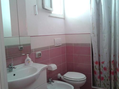 a bathroom with a toilet and a sink at Casadelpino Residence La Piana in Ponza