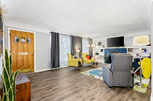 a living room with yellow chairs and a couch at CUTE Remodeled Midcentury Cottage on Boise Bench in Boise