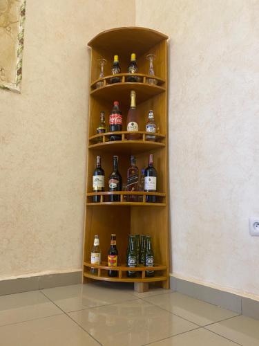 a shelf filled with different types of alcohol bottles at RÉSIDENCE MARTHA in Yaoundé