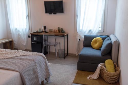 a bedroom with a blue chair and a desk at Luna Sul Tetto in Carpi