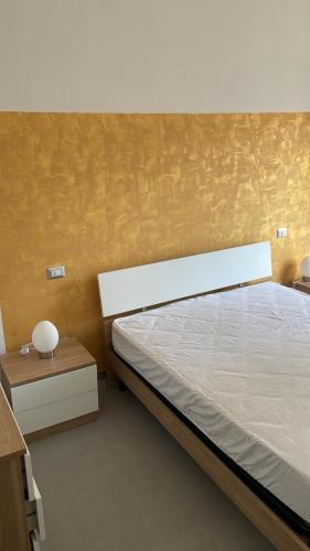 a bedroom with a large bed and a night stand at Le zagare in Palagiano