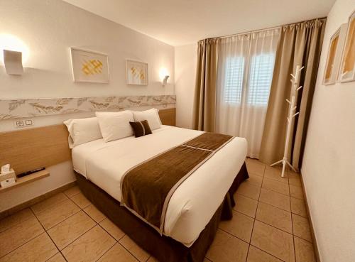 a bedroom with a large bed in a room at LUZ Vejer Hospedería in Vejer de la Frontera