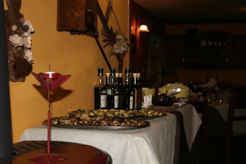 a tray of food on a table with bottles of wine at Hotel Etoile De Neige in Valtournenche