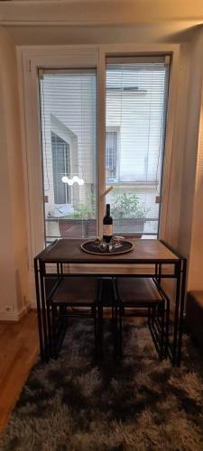 - une table dans une chambre avec 2 fenêtres dans l'établissement Cozy apt Heart of Paris, 3 mins Louvre, à Paris