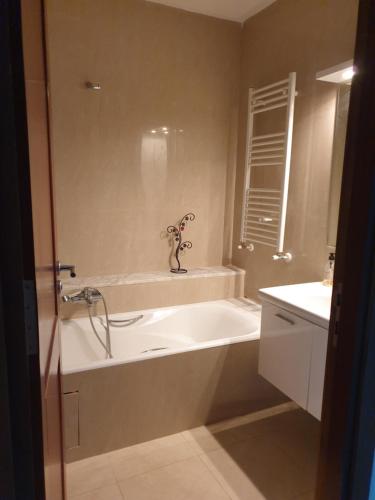a bathroom with a bath tub and a sink at Bright two bedroom apartment Lac2 Tunis Tunisia in Tunis