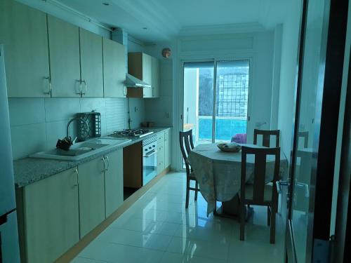 a kitchen with a table and chairs and a window at Bright two bedroom apartment Lac2 Tunis Tunisia in Tunis