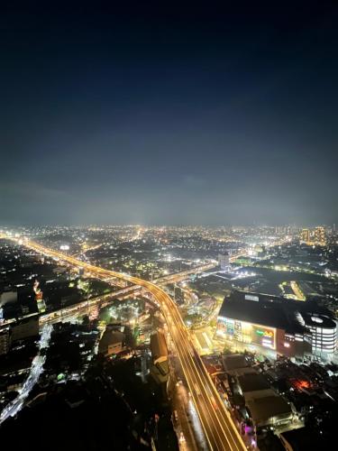 a view of a city at night with traffic at 1BR Condo Unit at Celandine Condominium Near Ayala Cloverleaf Mall in Manila