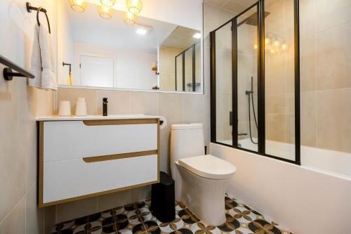 a white bathroom with a toilet and a shower at Cosy 3-Bedroom Home in Quiet Cul-de-Sac. in Pickering