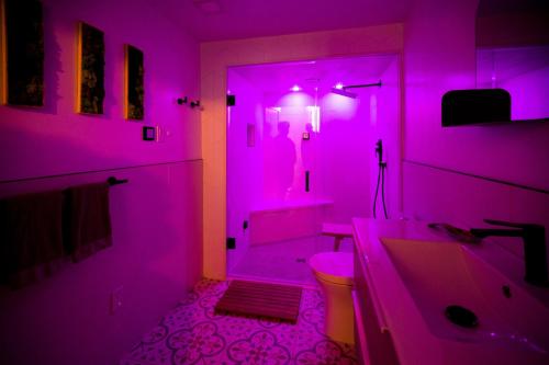 a purple bathroom with a toilet and a sink at Cosy 3-Bedroom Home in Quiet Cul-de-Sac. in Pickering