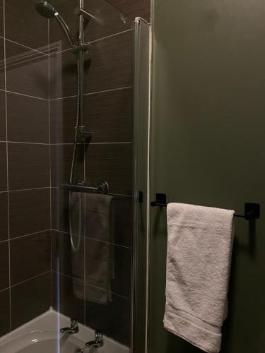 a bathroom with a shower and a white towel at Ship Inn Stays Ltd in Wylam