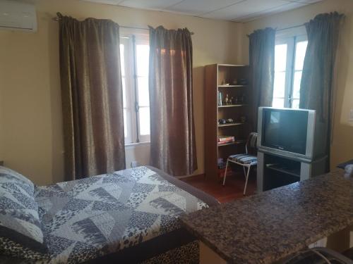Ένα ή περισσότερα κρεβάτια σε δωμάτιο στο Departamento en Luis Guillon