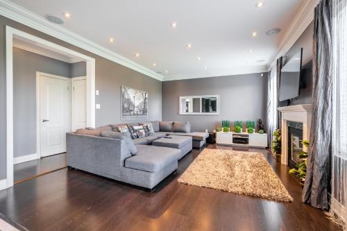 a living room with a couch and a fireplace at Beautiful Family Villa, Pond Facing with Huge Backyard in Brampton