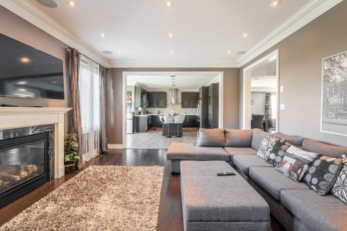 a living room with a couch and a fireplace at Beautiful Family Villa, Pond Facing with Huge Backyard in Brampton