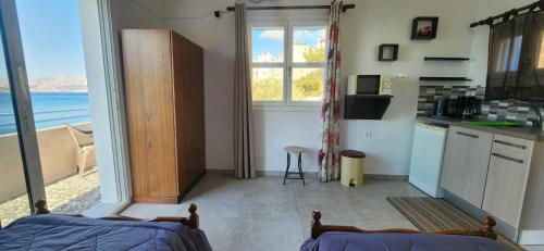 a kitchen with a view of the ocean from a room at Anna Studios in Myrties