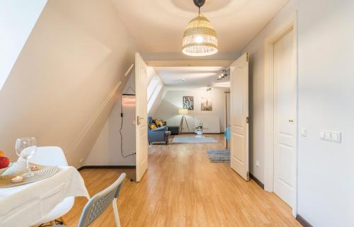 a living room with a table and chairs and a staircase at Lovely Old Riga studio in Rīga