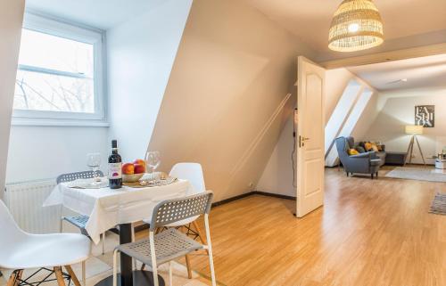 a dining room and living room with a table and chairs at Lovely Old Riga studio in Rīga