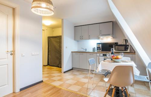 a kitchen and dining room with a table and chairs at Lovely Old Riga studio in Rīga