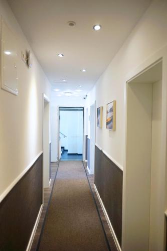 a corridor in a building with a hallway at JJ Hotel Hannover-City-Pension in Hannover