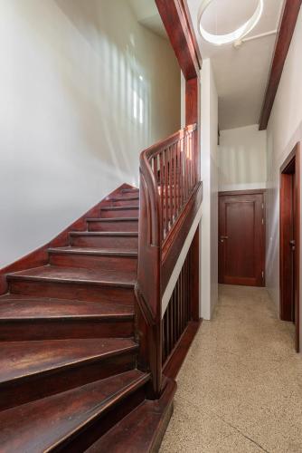 a staircase in a home with a wooden stair case at Hotel Beskid in Milówka
