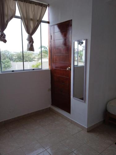 Habitación con puerta y ventana en Casa Piscina, Punta Mero, en Talara
