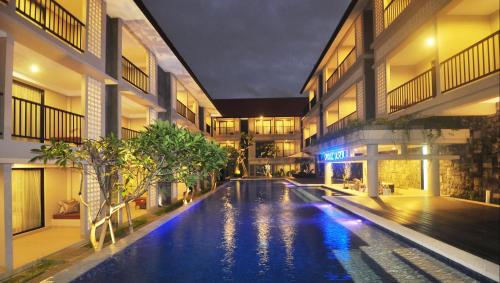 a swimming pool in the middle of a building at Grand Barong Resort in Kuta