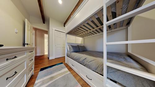 a bedroom with a bunk bed and a kitchen at Timberline Condominiums Two Bedroom Deluxe Unit D1D in Snowmass Village