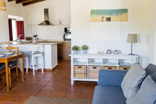 a kitchen and living room with a couch and a table at Monte Da Morena Agro-Turismo in Serpa