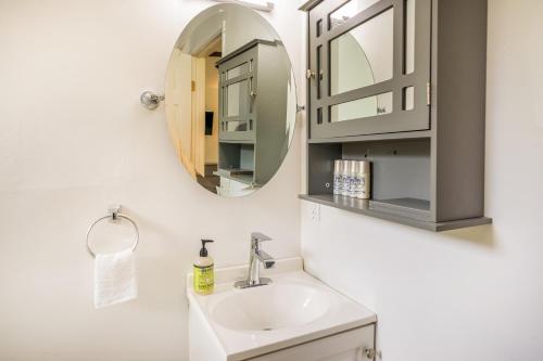 a bathroom with a sink and a mirror at Puni Mauka B 31 plus day rental in Pahoa