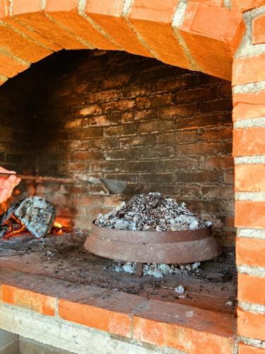 a brick oven with a fire inside of it at Casa Mia Resort in Kupres
