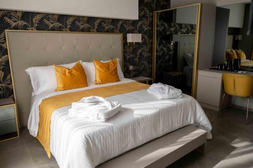 a bedroom with a large bed with towels on it at Divina Charme in Mascalucia