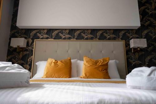 a bedroom with a bed with yellow pillows at Divina Charme in Mascalucia