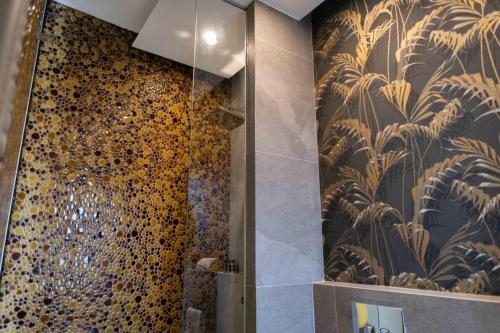 a bathroom with a shower with a patterned wall at Divina Charme in Mascalucia