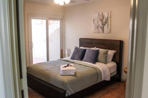 a bedroom with a large bed with a window at Lakefront Hacienda w/ Paddle Boat, Pool, Hot-tub, Tennis in Chandler