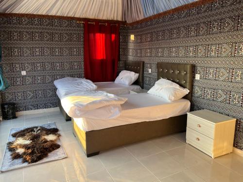 a bedroom with two beds in a room at Wadi Rum Desert Adventures in Wadi Rum