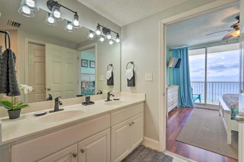a bathroom with two sinks and a large mirror at Resort Amenities Beachfront Panama City Condo! in Panama City Beach