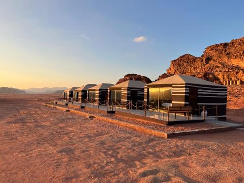a row of luxury tents in the desert at Wadi Rum Desert Adventures in Wadi Rum