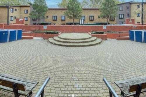a large amphitheater with benches and stairs in a courtyard at Bright, Nice Interior, Close to the City, 2 Bedroom Apartment in London