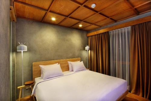 Кровать или кровати в номере Greenhost Boutique Hotel Prawirotaman