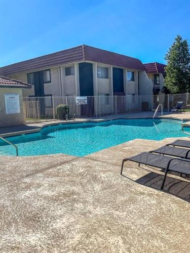 a swimming pool in front of a house at Upgraded Condo Close to All the Tempe Action in Tempe