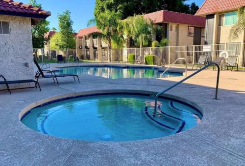 a small swimming pool with a hose in a courtyard at Upgraded Condo Close to All the Tempe Action in Tempe