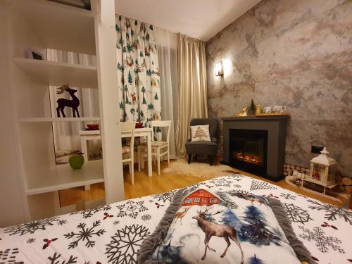 a bedroom with a bed and a fireplace at Pinewood ANG Apartment, Semiramida Borovets Hills in Borovets