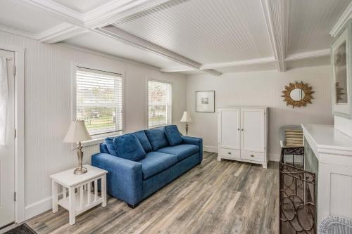 a living room with a blue couch and a table at Cannon Beach Hotel Collection in Cannon Beach