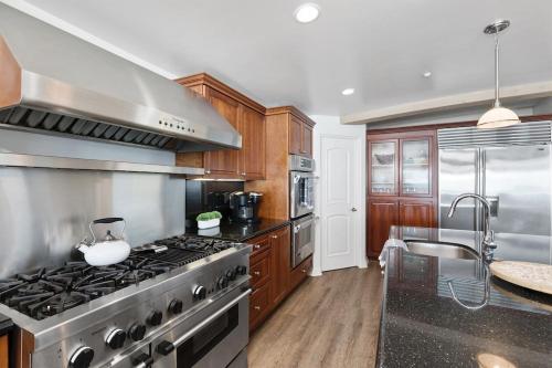 a kitchen with a stove and a sink at Oceanfront, Private Patio, BBQ, On The Strand in Oceanside