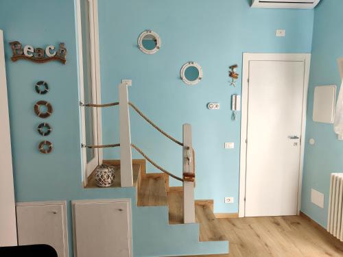 a blue wall with stairs in a room at The Sorabellas in Gaeta