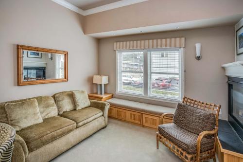 a living room with a couch and a window at Cannon Beach Hotel Collection in Cannon Beach