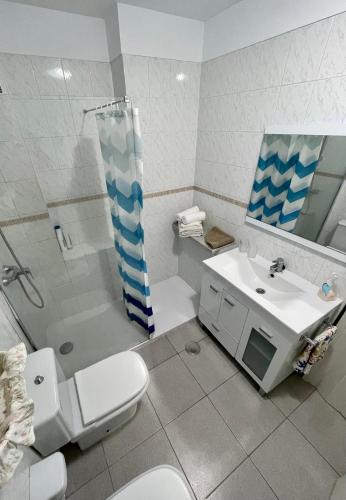 a bathroom with a toilet and a sink and a shower at Medano View in El Médano