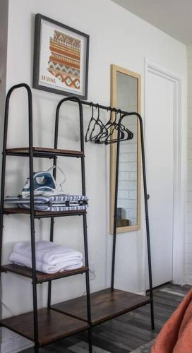 a black shelf in a room with a mirror at Adorable Ground Level Boho Studio Blocks From Dwntn-C in Tempe