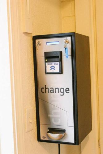 a change machine is attached to a wall at Adorable Ground Level Boho Studio Blocks From Dwntn-C in Tempe