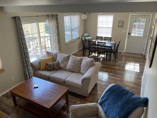 a living room with a couch and a table at Lakeshore Fishing Cabin #12 , dock/boat slip/ramp on location in Lake Ozark