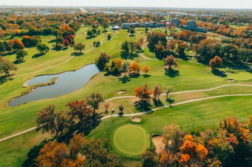 an aerial view of a golf course with a pond at Eaglewood Resort & Spa in Itasca